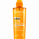 زيت Bioxcin Sun Care للتسمير بعامل حماية SPF 15+ – بخاخ 200 مل